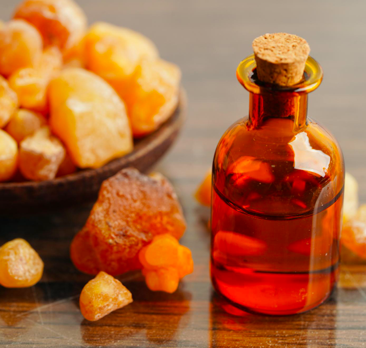 Vintage apothecary bottles and fragrant resins inspiring the Amber Scented Candle